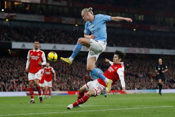 Manchester City's Norwegian striker Erling Haaland (C up) fights for the ball with Arsenal's Japanese defender Takehiro Tomiyasu during the English Premier League football match between Arsenal and Manchester City at the Emirates Stadium in London on February 15, 2023. (Photo by Ian Kington / IKIMAGES / AFP) / RESTRICTED TO EDITORIAL USE. No use with unauthorized audio, video, data, fixture lists, club/league logos or 'live' services. Online in-match use limited to 120 images. An additional 40 images may be used in extra time. No video emulation. Social media in-match use limited to 120 images. An additional 40 images may be used in extra time. No use in betting publications, games or single club/league/player publications. /