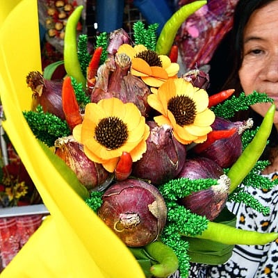 A florist arranges a bouquet of onions for sale at a flower market in Manila on Valentine's Day. AFP