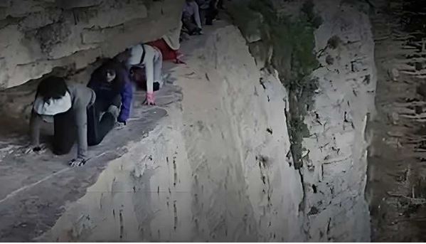 游客无保护措施「狗爬式」过悬崖　「是旅游还是玩命？」